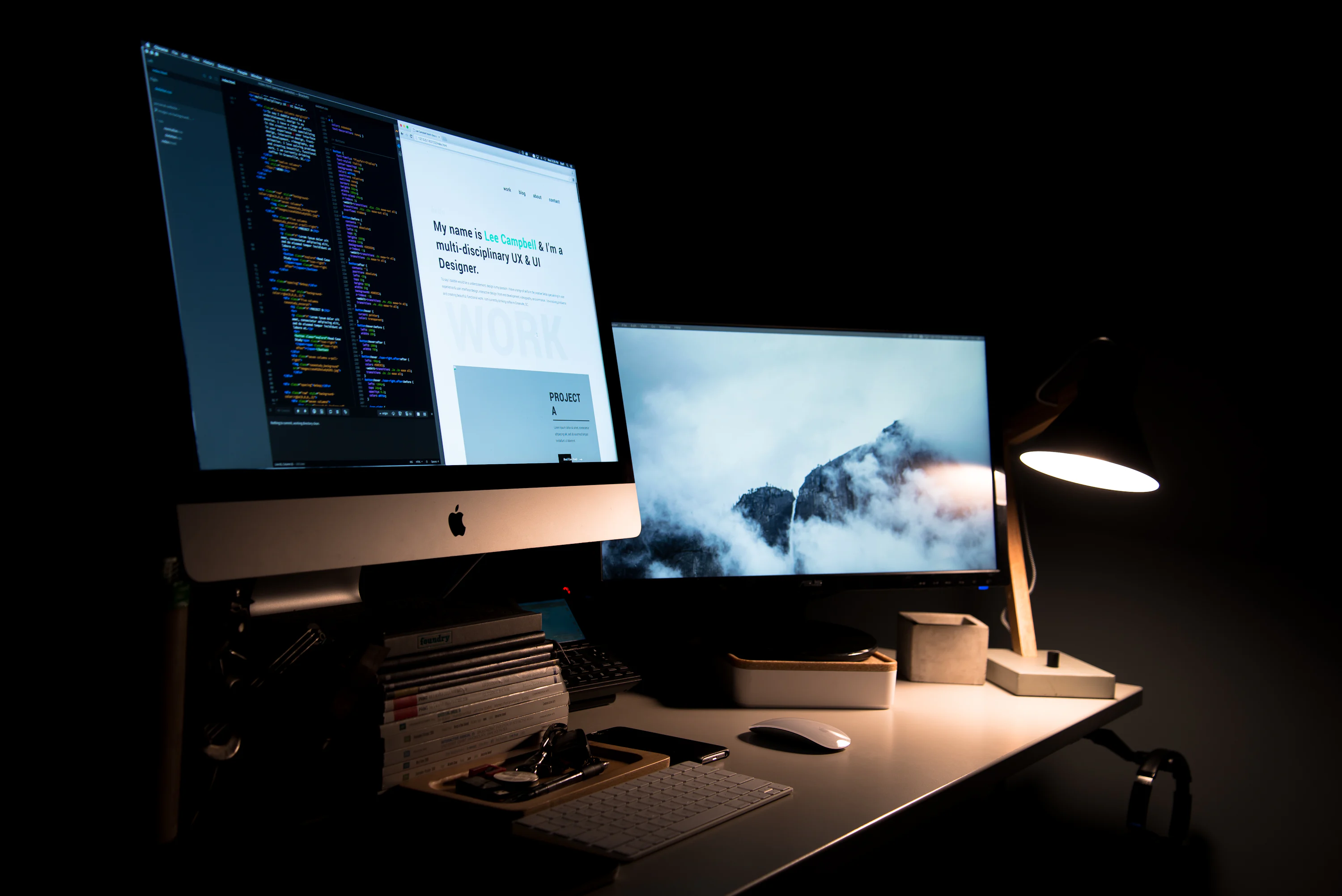 Professional desk setup with MacBook and iMac showing website analytics